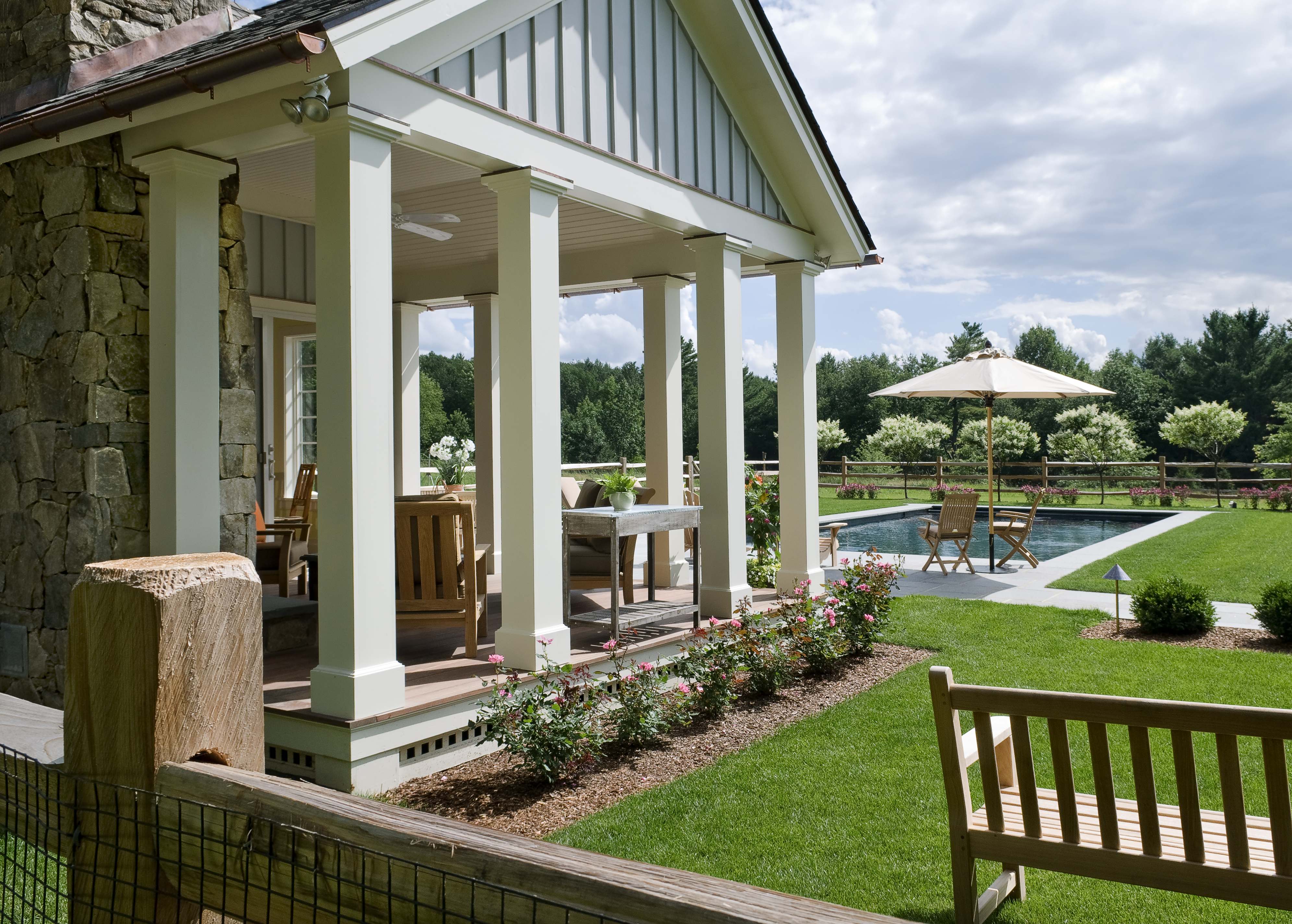 Covered porch pavilion overlooking pool and gardens