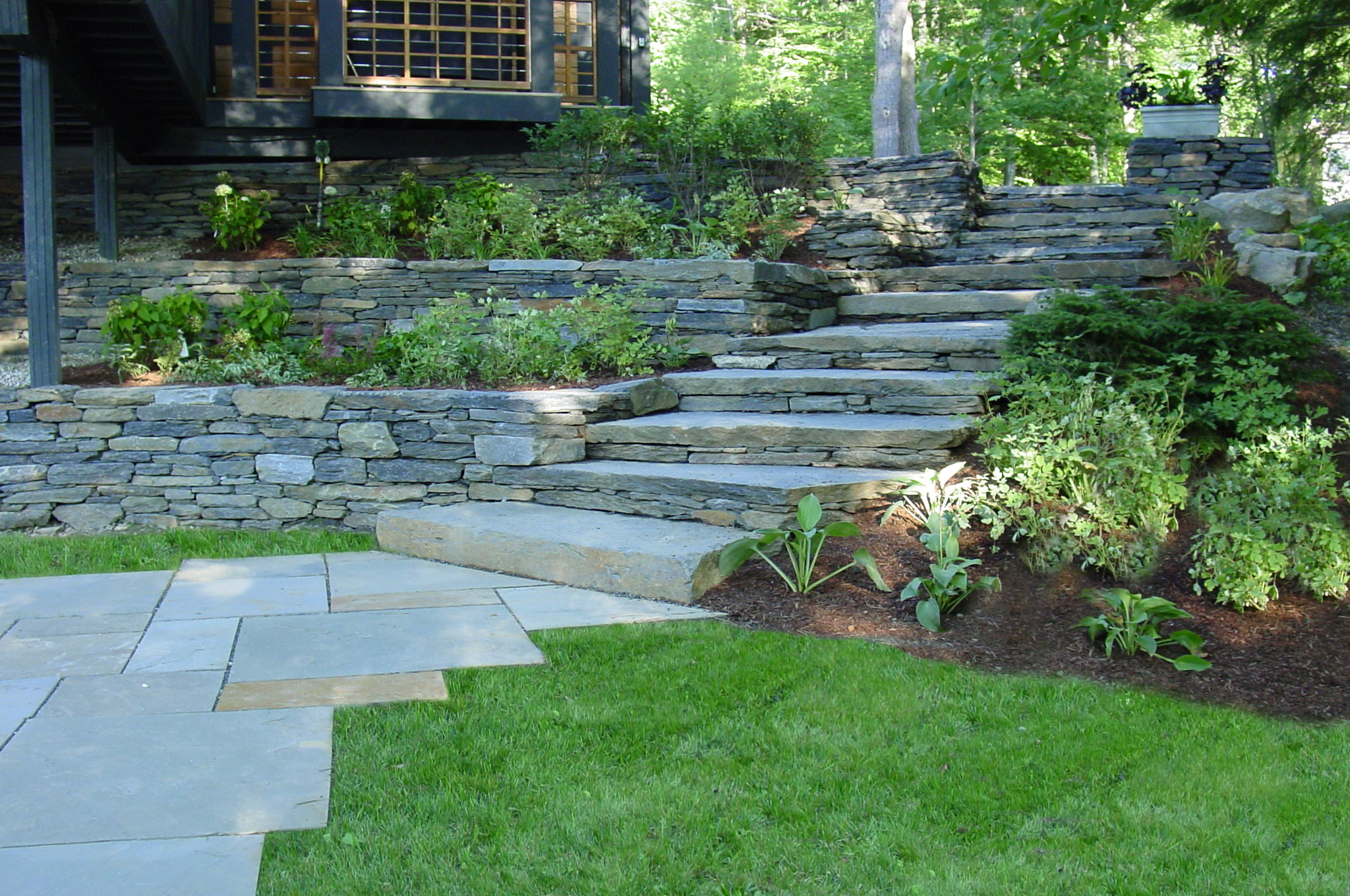 Natural stone stairs and retaining walls with landscaping