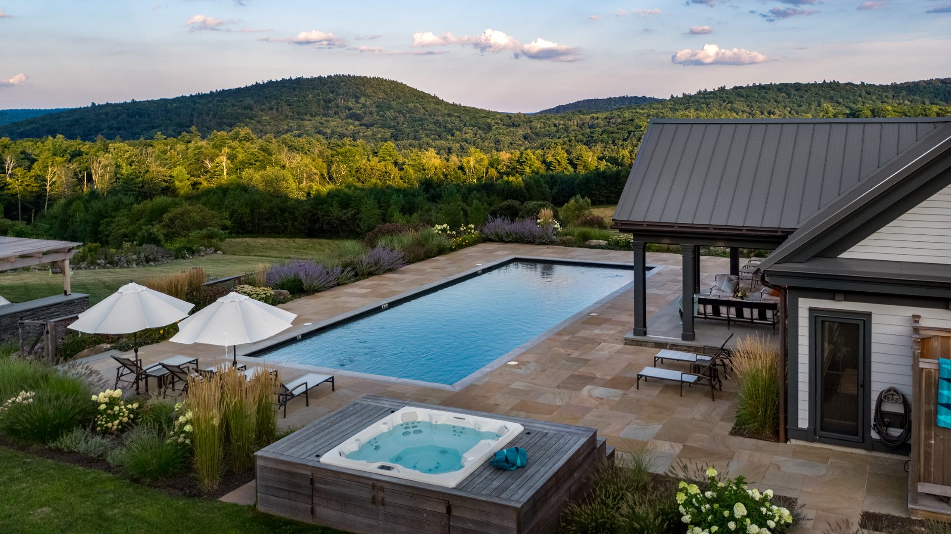 Home Poolside terrace overlooking the Berkshire hills at golden hour