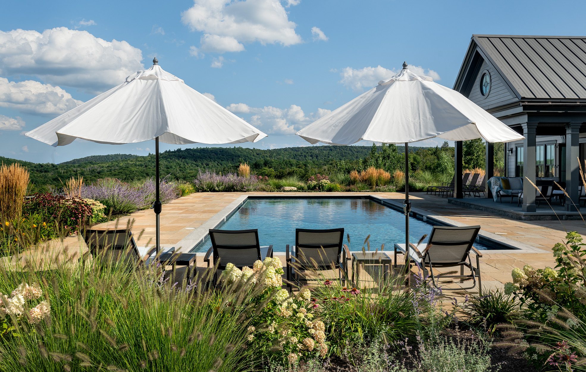 Services Poolside loungers and umbrellas in a designed landscape